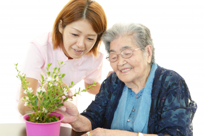 elderly woman smiling with female caregiver