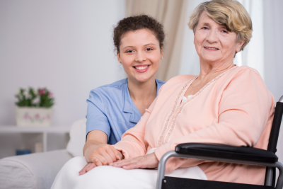 senior woman smiling with female caregiver